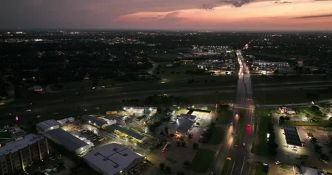 Forward flight viewing business highways and traffic as night sets in Stock Footage 335669916