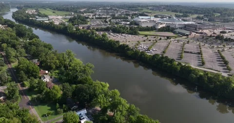 Forward flight viewing hotel complex over river and hills and trees beyond Stock-Footage 335674639
