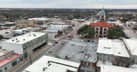 Forward flight viewing old downtown retail buildings and the county courthouse Stock Footage 236262875