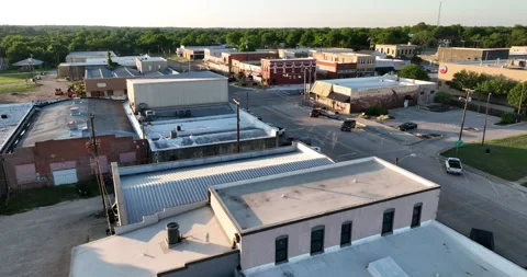 Forward flight viewing old storefronts and shops in a small town Video stock 335671546