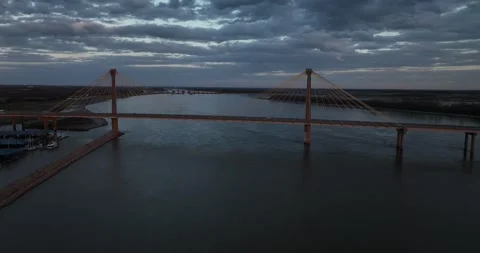 Forward flight viewing a suspension bridge over the river Video stock 335669430
