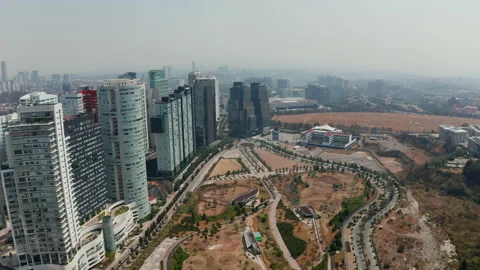 Forward fly above public park. Panoramic aerial view of skyscrapers in modern Stock Footage 156949927