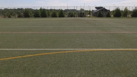 Forward Fly Over Across Soccer Field into Goal Stock Footage 82045818
