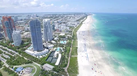 Forward Flying Drone Shot Tilting over South Beach in 4K Stock Footage 64738177