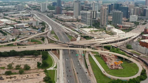 Forward flying drone towards huge multilane highway intersection in town. Aerial 스톡 동영상 155543383
