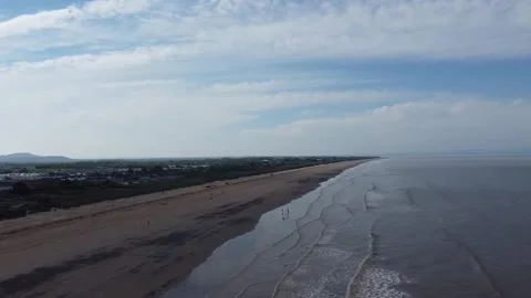 Forward flying drone tracking shot along Brean Sands beach Stock Footage 329983819