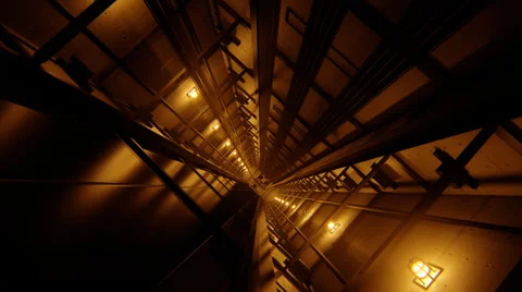 Forward flythrough of a dim industrial corridor with warm amber light Stockbeeldmateriaal 51207719