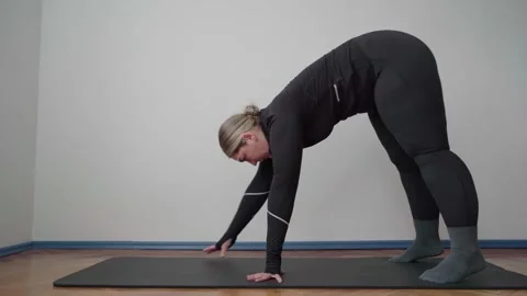 Forward Fold Walk-Out Stretch for Tight Hamstrings and Spine Health Stockbeeldmateriaal 340544993