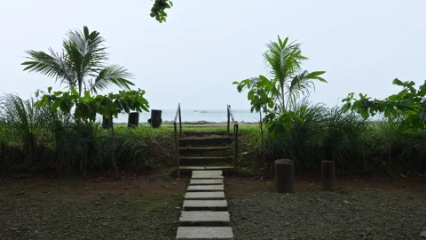 Forward Motion Along Stone Path and Steps Toward Tropical Beach and Ocean View Stock Footage 335382346