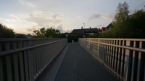 Forward Motion on Metal Pedestrian Bridge at Golden Hour, Quaint European Vídeo Stock 345995004