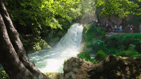 Forward motion shot of Marmore Waterfall surrounded by forest Stock Footage 315347880