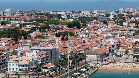 Forward motion towards Portuguese flag overlooking Cascais bay, Portugal in the Stock Footage 196990695