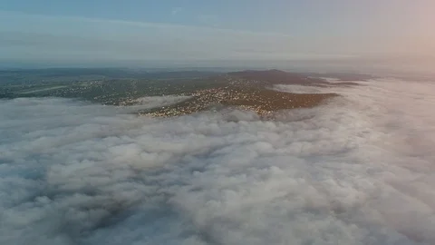 Forward movement of an aereal view with a big settlements on the hills covered Stock Footage 127171838