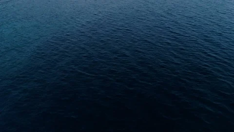 Forward movement over dark blue calm sea surface aerial shot of beautiful waves Stock Footage 94825400