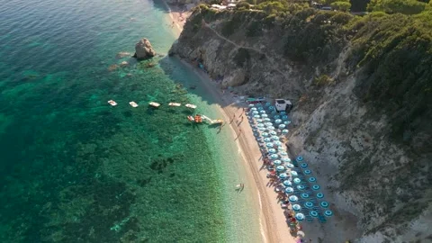 Forward Moving Drone Shot Approaching Spiaggia di Sansone Beach Umbrellas  .. Stock Footage 326471695
