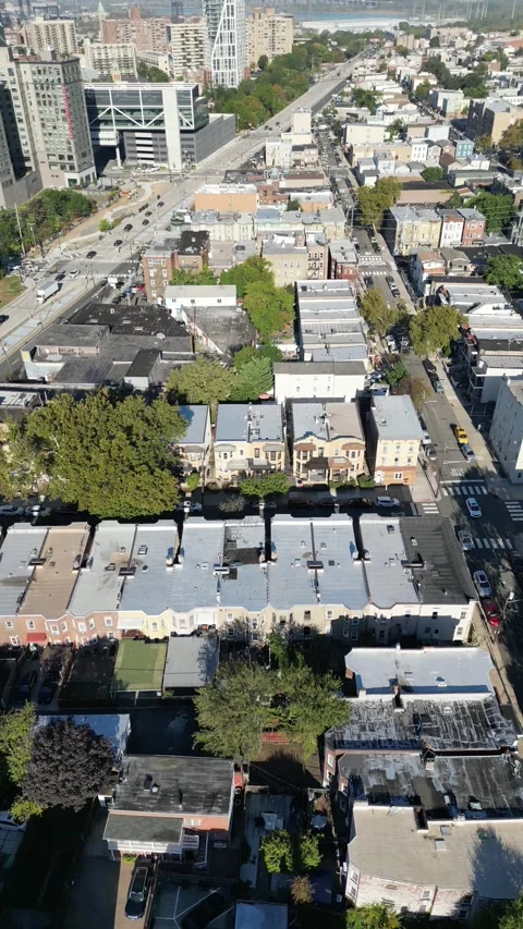 Forward-moving drone shot over Jersey City displaying residential lines, angled Stock Footage 321883335