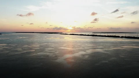 Forward moving drone shot over tropical water at sunset in the Florida Keys Stock Footage 336194933