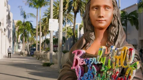 Forward moving gimbal shot Rodeo Drive Mona Lisa sign Beverly Hills Stock Footage 332619367