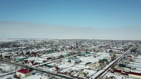 Forward moving with right turn aerial shot over snowed town when sunny Stock Footage 166436977