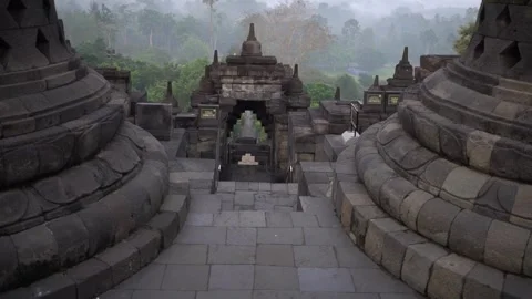 Forward Moving Shot Through Stone Archway Gate at Borobudur Temple Stock Footage 338274929