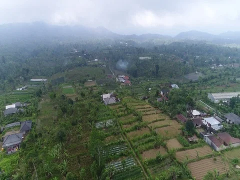Forward over small town in Bali Indonesia into the clouds. Stock Footage 80148736