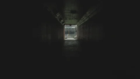Forward panning POV shot of tunnel in stadium heading towards football field Stock Footage