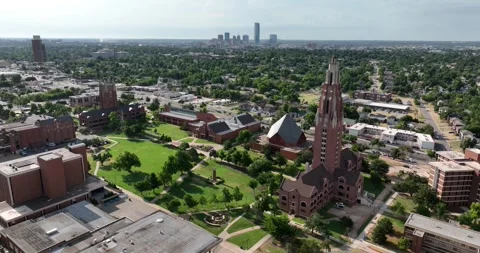 Forward past Memorial Towercampus buildings grounds downtown OKC background Stock Footage 335673909