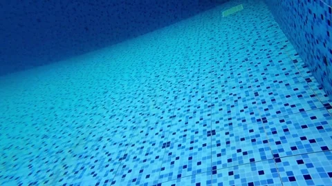 Forward pushing camera view of swimming pool floor Stockbeeldmateriaal 345493284