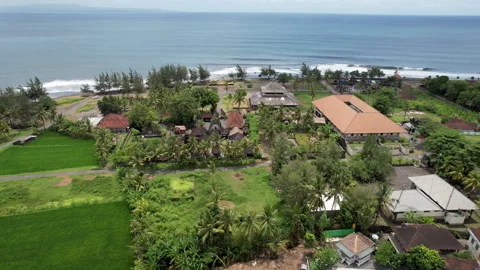 Forward reveal tilt down drone shot of Pura Masceti hindu temple on sunny day Stock Footage 285097506