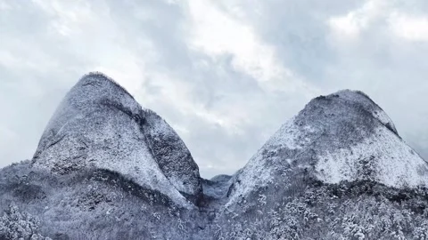 Forward Rising Aerial Approaching Snow-Covered Twin Peaks of Maisan Stock Footage 344248068