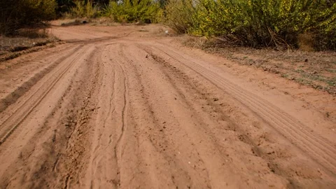 Forward on a sandy desert path - wheel imprints Stock-Footage 257185867