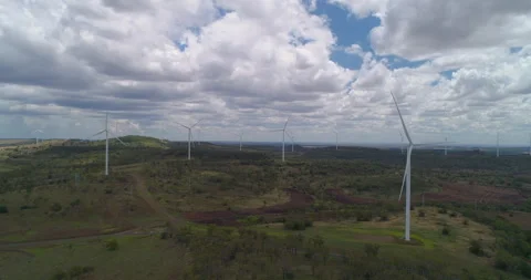 Forward side tracking view of  Wind Turbines at wind farm, QLD, Australia Stock Footage 297593689