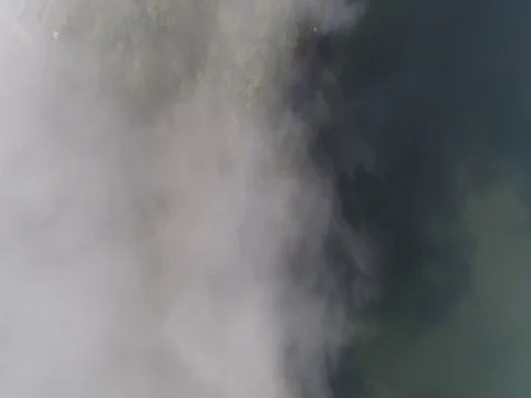 Forward through clouds, looking down over small town and lake in Bali Indonesia. Stock Footage 80142500