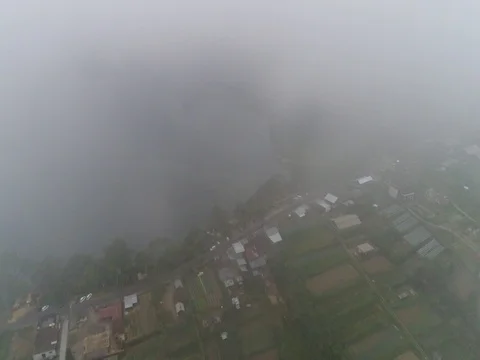 Forward through clouds, over small town and lake in Bali Indonesia Stock Footage 80148732