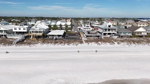 Forward tilted drone fly to the new beachfront empty lot facing wide sandy Stock-Footage 332078290