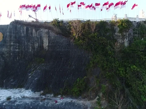 Forward toward and over rock cliffs showing construction in Bali Indonesia. Stock Footage 80156915