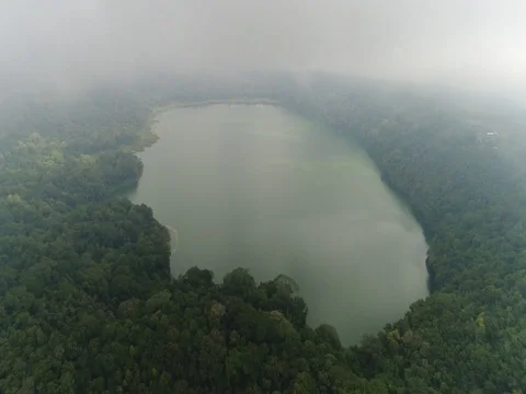 Forward toward and over small lake in Bali Indonesia with clouds. Stock Footage 80142333