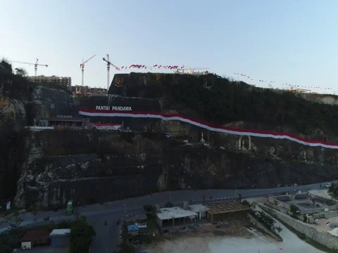 Forward toward rock cliffs and construction in Bali Indonesia. Stock Footage 80151482