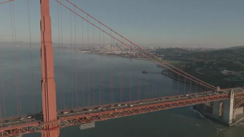 Forward tracking drone flying over bridge tower with city Stock Footage 336792998