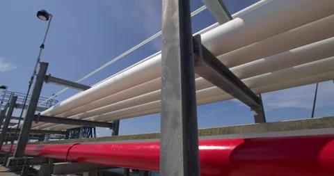 Forward Tracking Low Angle Shot of Coastal Petroleum Pier Pipelines Stock Footage 346138370