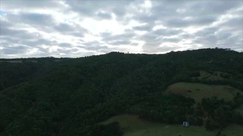 Forward tracking overall view of hill with fields Stockbeeldmateriaal 340992317