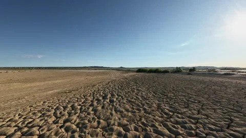 Forward tracking shot over cracked arid mud flat Stock Footage 346849321