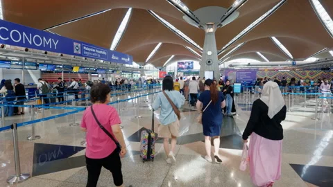 Forward Tracking Shot of Passengers at Check-In in KLIA Malaysia Stock Footage 343341358