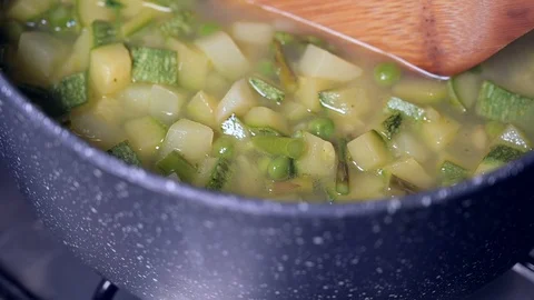 Forward tracking shot of vegetable soup in the pot Stock Footage 129848490