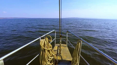 Forward view from the deck white steel yachts going under the motor on dark blue Stock Footage 75024949