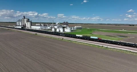 Forward viewing an ethanol plant train cars on siding farm fields all around Stockbeeldmateriaal 335670007