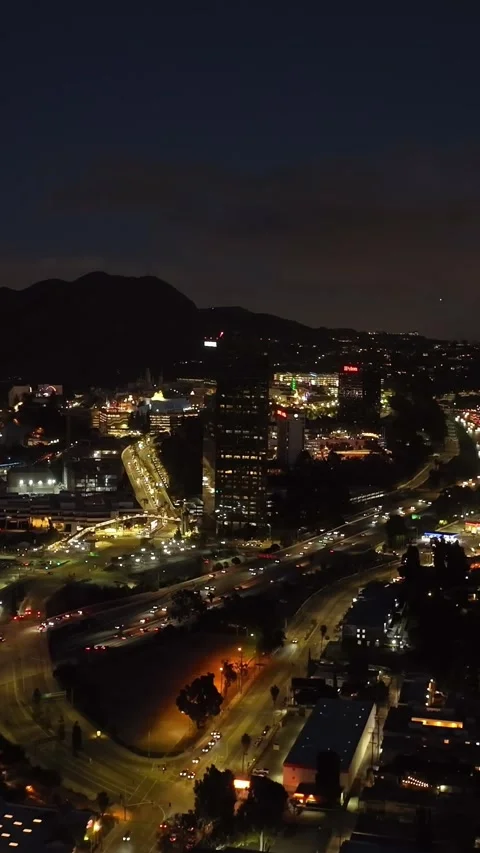 Forwards fly above evening city. Busy transport infrastructure leading through S Video stock 337414244