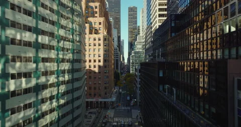 Forwards fly above street between modern high rise buildings with colour facades Vídeos de archivo 167751376