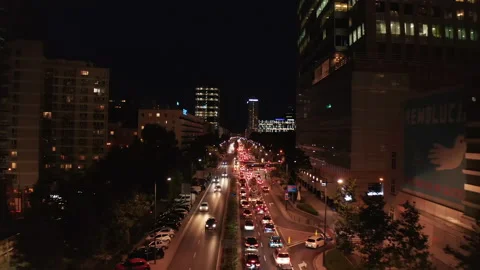 Forwards fly above traffic jam in evening city streets. Long queue of cars Stock Footage 165364645