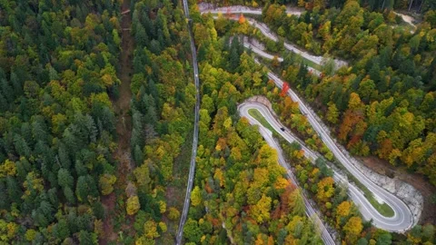 Forwards oriented flight over Mendel mountain pass road in colorful fall Stock Footage 254865369